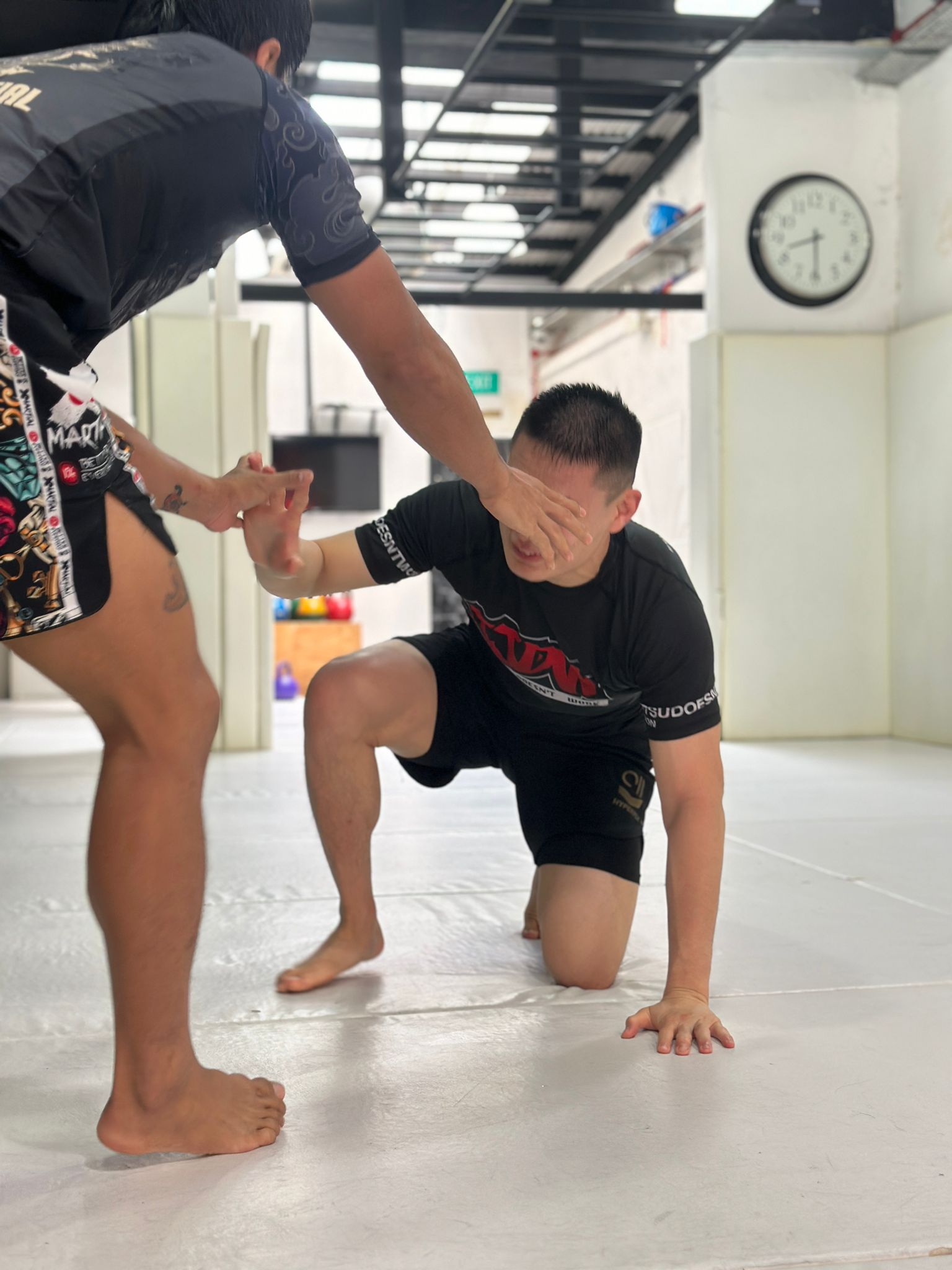 Wrestlers practising a standing-to-ground transition at The Gentle Art Academy